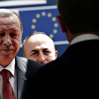 President Erdogan arrives at the European Council building in Brussels flanked by security