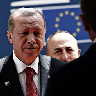 President Erdogan arrives at the European Council building in Brussels flanked by security